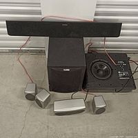 Full set: soundbar, subwoofer, loose driver/amp plate, four satellites, center