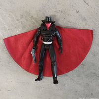 Front view of The Shadow action figure with red-lined cape and pistol