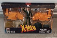 Front of sealed Marvel Legends Professor X box showing figure, hover chair parts, accessories