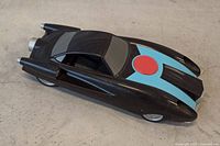 Top perspective of black toy car showing blue stripe and red circle emblem