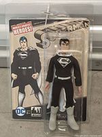 Front of sealed blister card showing Superman black suit figure