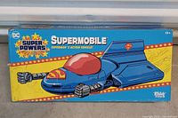 Front of box showing Supermobile graphics and branding