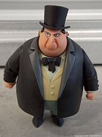 Front view of The Penguin figure showing attire and facial detail