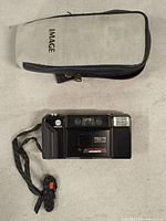 Front view of Minolta AF-E camera and soft case