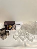 All three napkin ring types grouped: crystal hearts, stainless cylinders, boxed silver-plated set