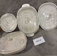 Three casserole dishes with lids shown from above to display shape and lids