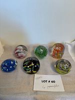 All six paperweights grouped, front and overhead view