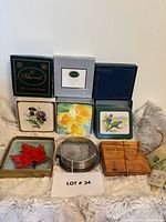 All six coaster sets group shot with boxes and sample coasters