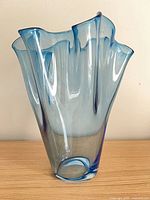 Front view of translucent blue glass vase showing ruffled rim