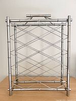 Front view of chrome bamboo-style wine rack showing lattice bottle supports and overall structure