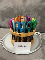 Full view of wooden carousel filled with multicolour craft scissors