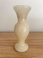 Full view of cream stone vase front