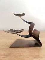 Side view showing twisted ribbon body and two square platforms