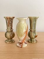 Front view of three green onyx bud vases