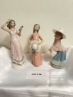 All three porcelain figurines standing on surface