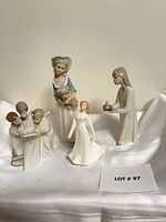 Group shot of all four figurines arranged together