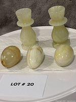 view of both onyx candlesticks and three eggs