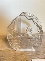 Front view of clear glass relief sculpture showing child and window scene