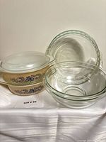 Stacked Pyrex Homestead casseroles with clear bowls and pie plates