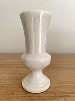 Front view of white marble pedestal vase
