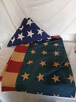 Folded triangular flag beside partially unfolded flag