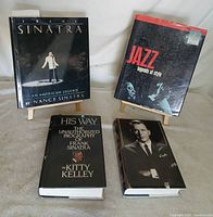 All four hardcover books displayed upright and flat