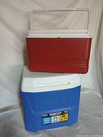Blue Igloo rolling cooler stacked with red Legend cooler