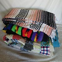 Stack of three blankets showing colours and patterns
