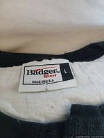 Badger Sport label on cream henley shirt size L
