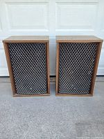 Front view of both Sansui SP-2500 speakers showing lattice grills and wood cabinets