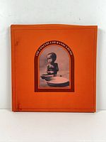 Front of orange box with title and photo