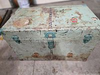 Closed chest showing exterior paint, decals, hardware and wear