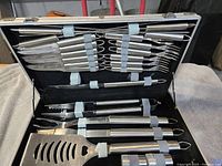 Open case showing all utensils strapped inside