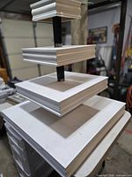 Full view of 4-tier white wood display stand on table