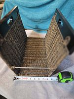 Interior view showing wicker weave, wood ends, support rods and tape measure indicating length