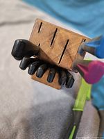 Top view of wooden block showing three large knife handles and six steak knife handles