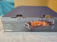 Retail box showing Paderno Signature hard anodized non-stick roaster with V-rack and cooked chicken image