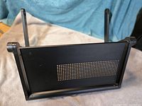 Overall view of black ventilated laptop stand upright