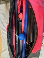 Game components inside carry bag showing tubes and bolas