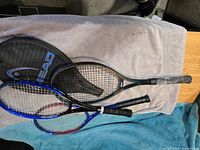 Top view of three rackets stacked with Head cover visible