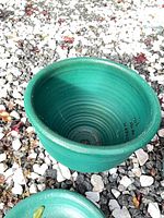 Green ceramic planter interior view showing glaze and drainage hole