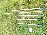 All five extension poles laid out on grass
