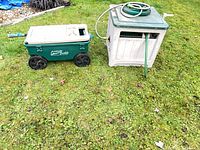 Ames Lawn Buddy cart beside hose reel box on grass