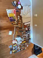 Entire lot laid out: drop cloths, tools, sander, sandpaper, fillers