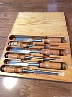 Six Eskilstuna chisels in open wooden case, horizontal view