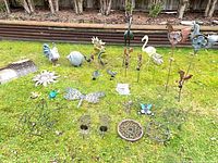 Overall shot of mixed metal garden décor laid out on lawn