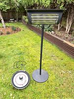 Full view of bar heater on pole with base and disc heater on ground