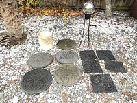 Group shot of all items: five round mats, five square mats, stoneware crock, decorative orb on stand