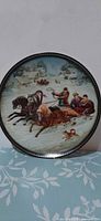 Full view of front of plate showing winter troika scene and gold rim