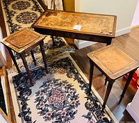 Hall table with two nesting tables pulled out showing tops and rug beneath